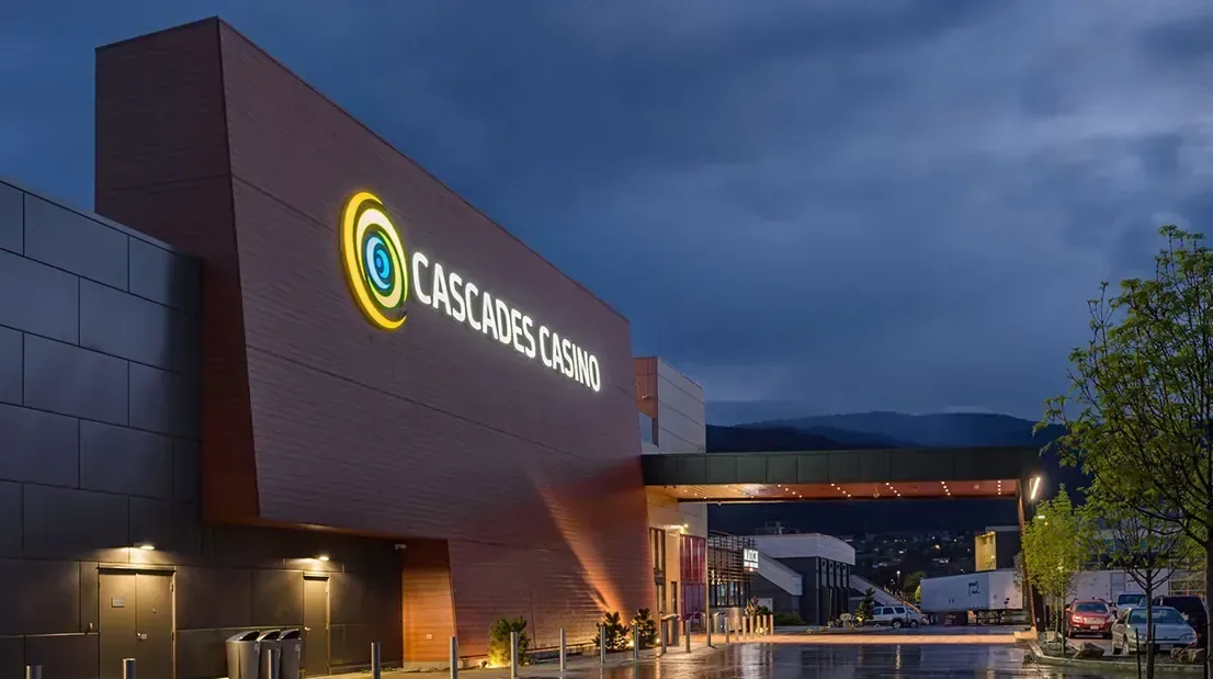 The Cascades Casino building in Langley, British Columbia, with its illuminated sign at dusk
