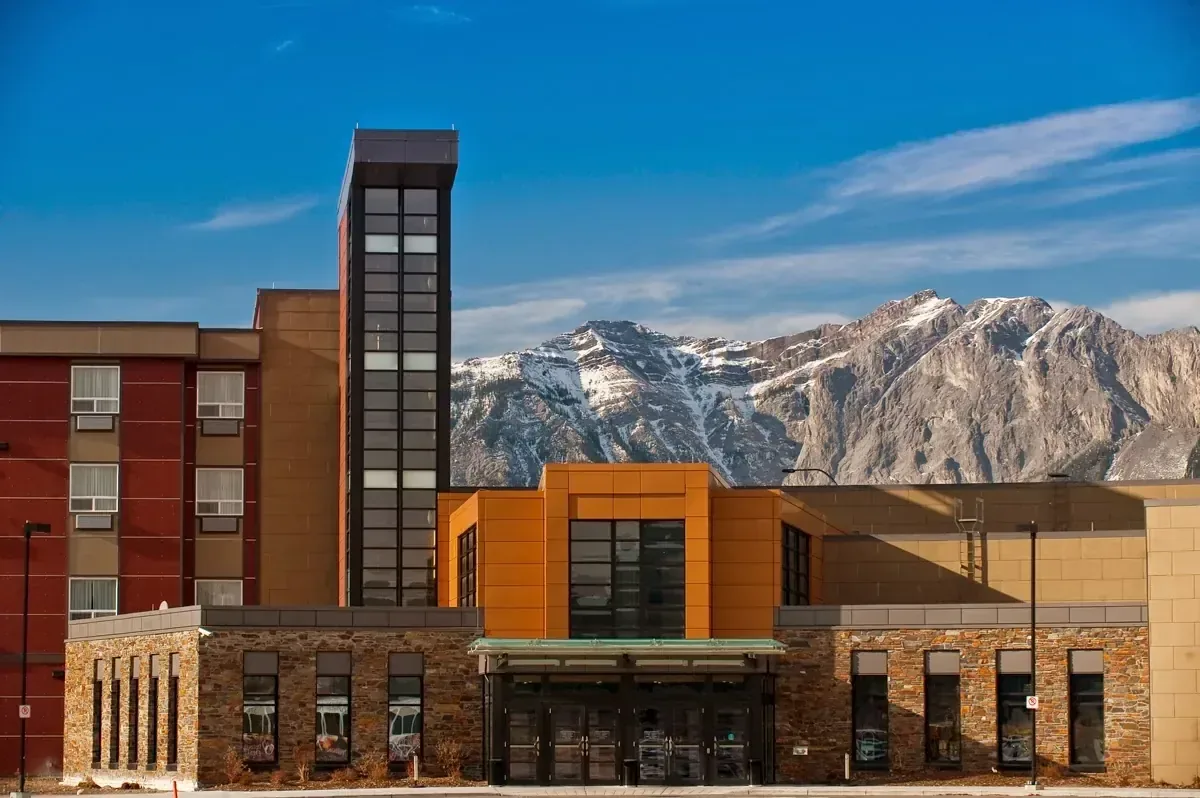 The Stoney Nakoda Resort & Casino building in Kananaskis, Alberta, with mountain peaks rising behind it